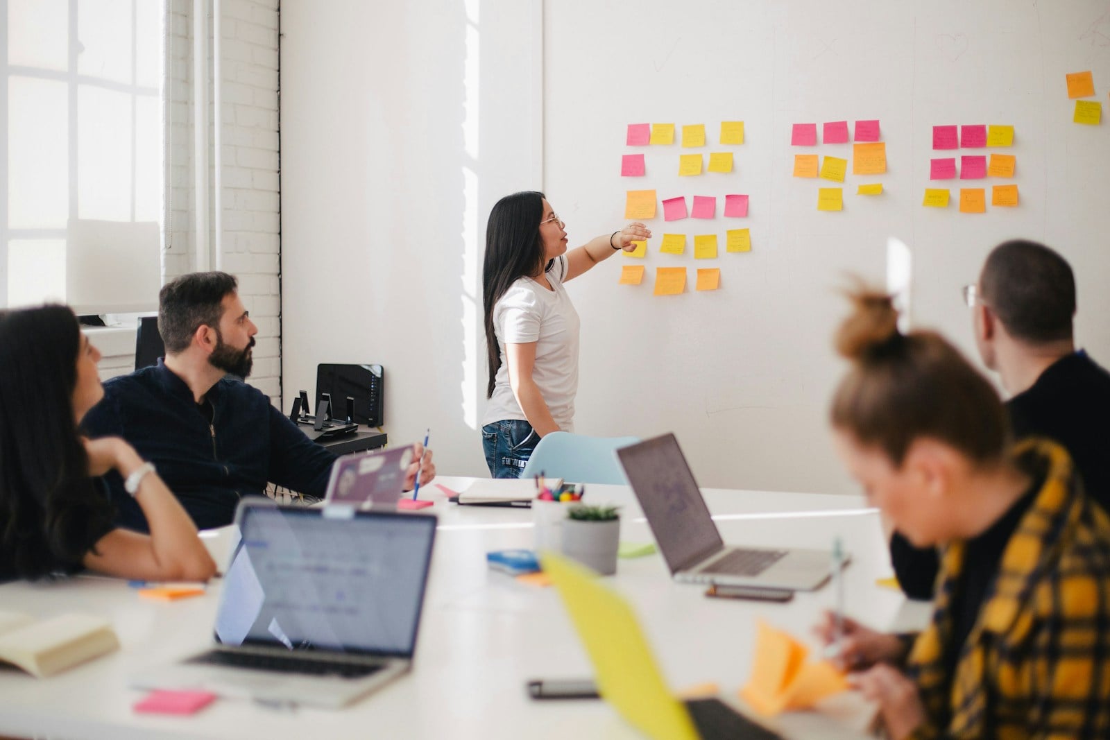 Photographie d’illustration : une équipe mixte en atelier de travail autour d’un tableau